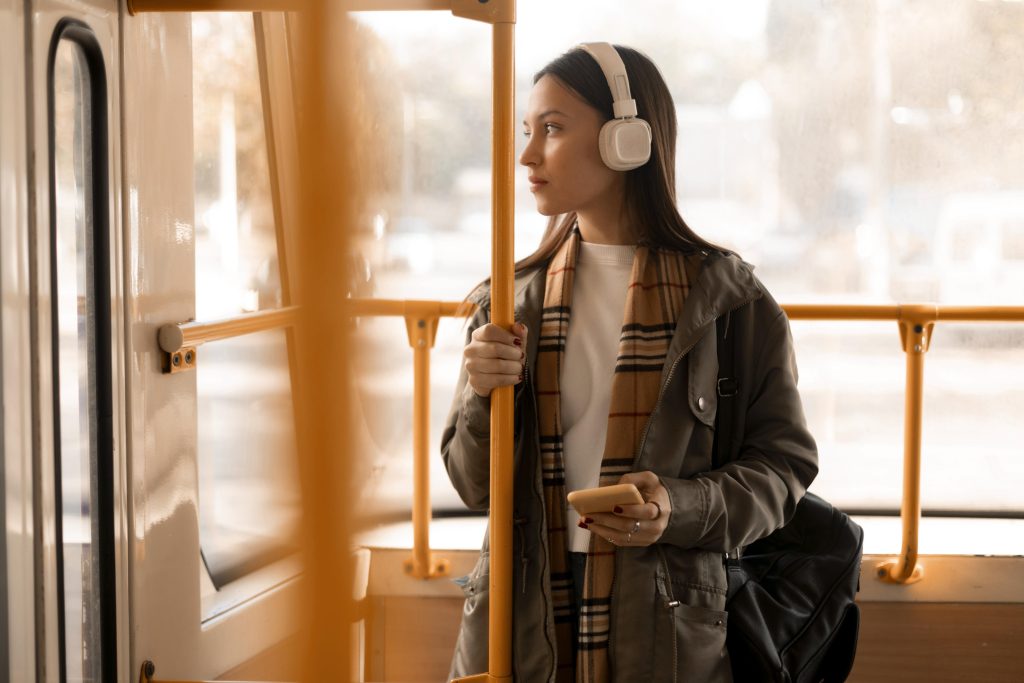 Passenger enjoying music on a tram with headphones