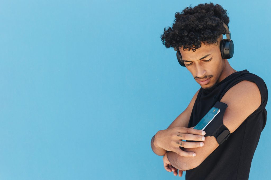 Person using smart headphones during a workout, with icons showing heart rate monitoring and voice assistant commands