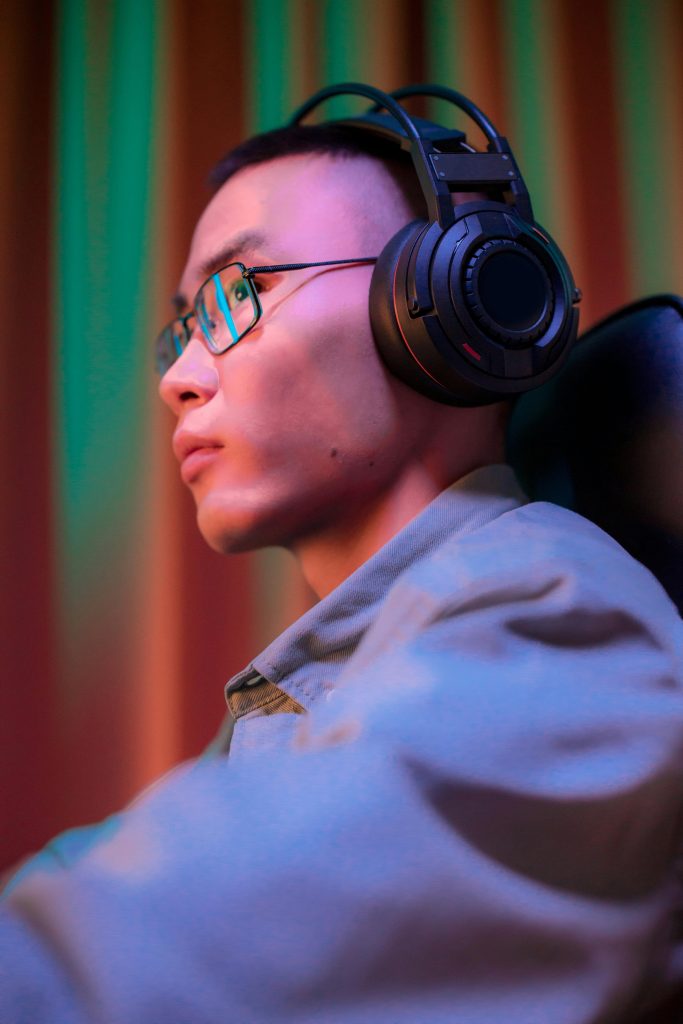 Gamer wearing Razer Kraken headset, fully immersed in their gaming experience with clear sound and comfort.