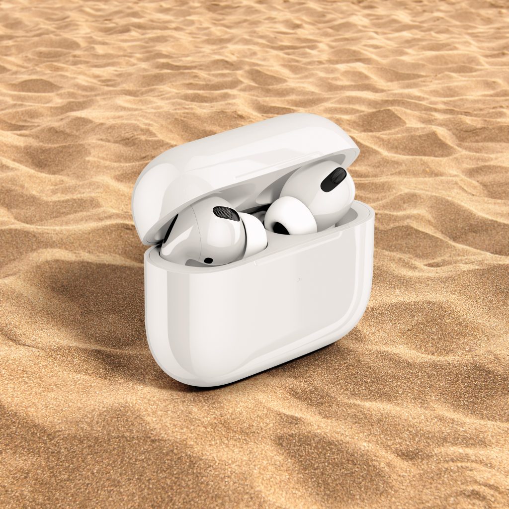 Person cleaning Apple earbuds with a cotton swab and microfiber cloth